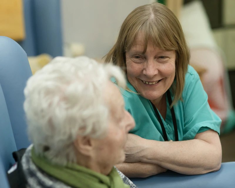 Caregiver smiling with a patient